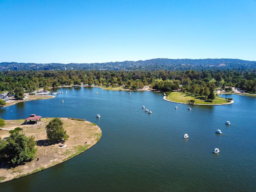 Aerial view of a San Fernando Valley lake park with paddle boats and tree-lined shoreline