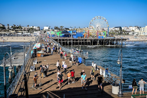 Crowded Santa Monica Pier with Ferris wheel and ocean views