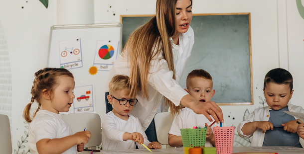 Talk-EarlyEd — teacher guiding children during a classroom activity